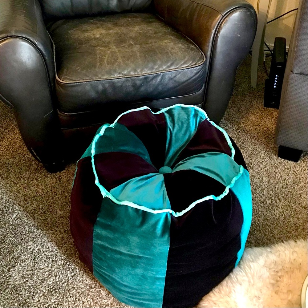 Handmade pouf in rich purple and teal velvet.